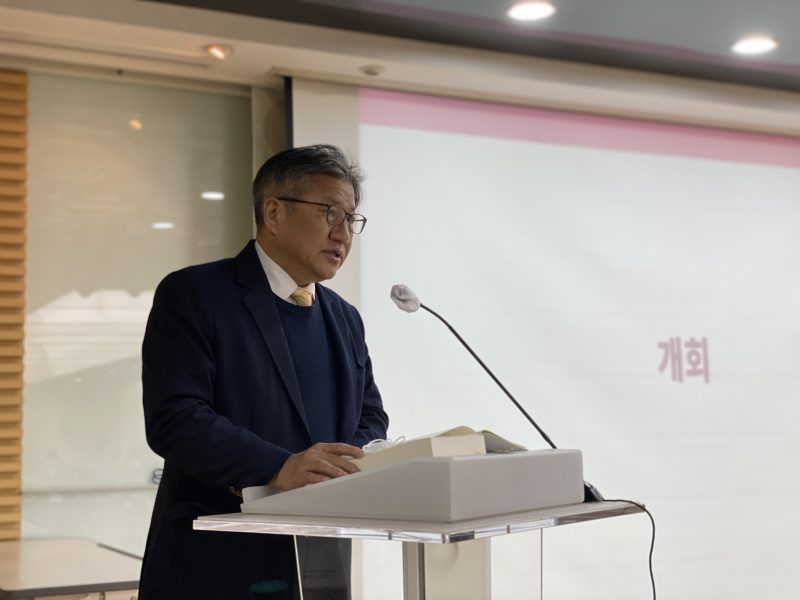 조영선 회장이 연단 마이크 앞에서 서서 발언하고 있다. 조영선 회장 뒤로 "개회"라고 써있는 PPT가 띄워져 있다.